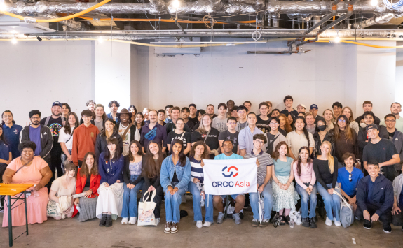 A group of CRCC students pose for a photo holding a CRCC banner